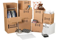 Moving Boxes & Supplies - Boxes and other materials of a moving kit, some open and containing clothing, books, stuffed animals, and other items